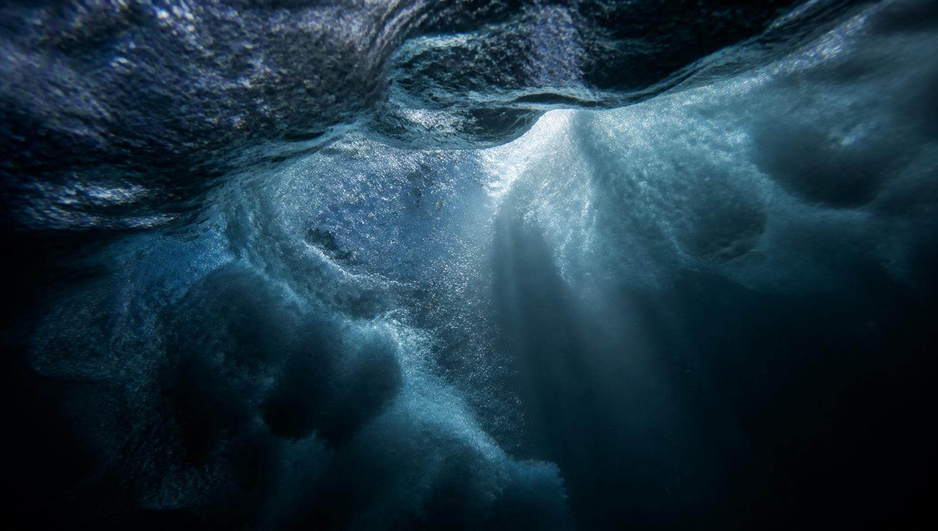 Underwater turbulence and light beneath a breaking wave